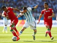 Mehrdad Pooladi of Iran and Lionel Messi of Argentina